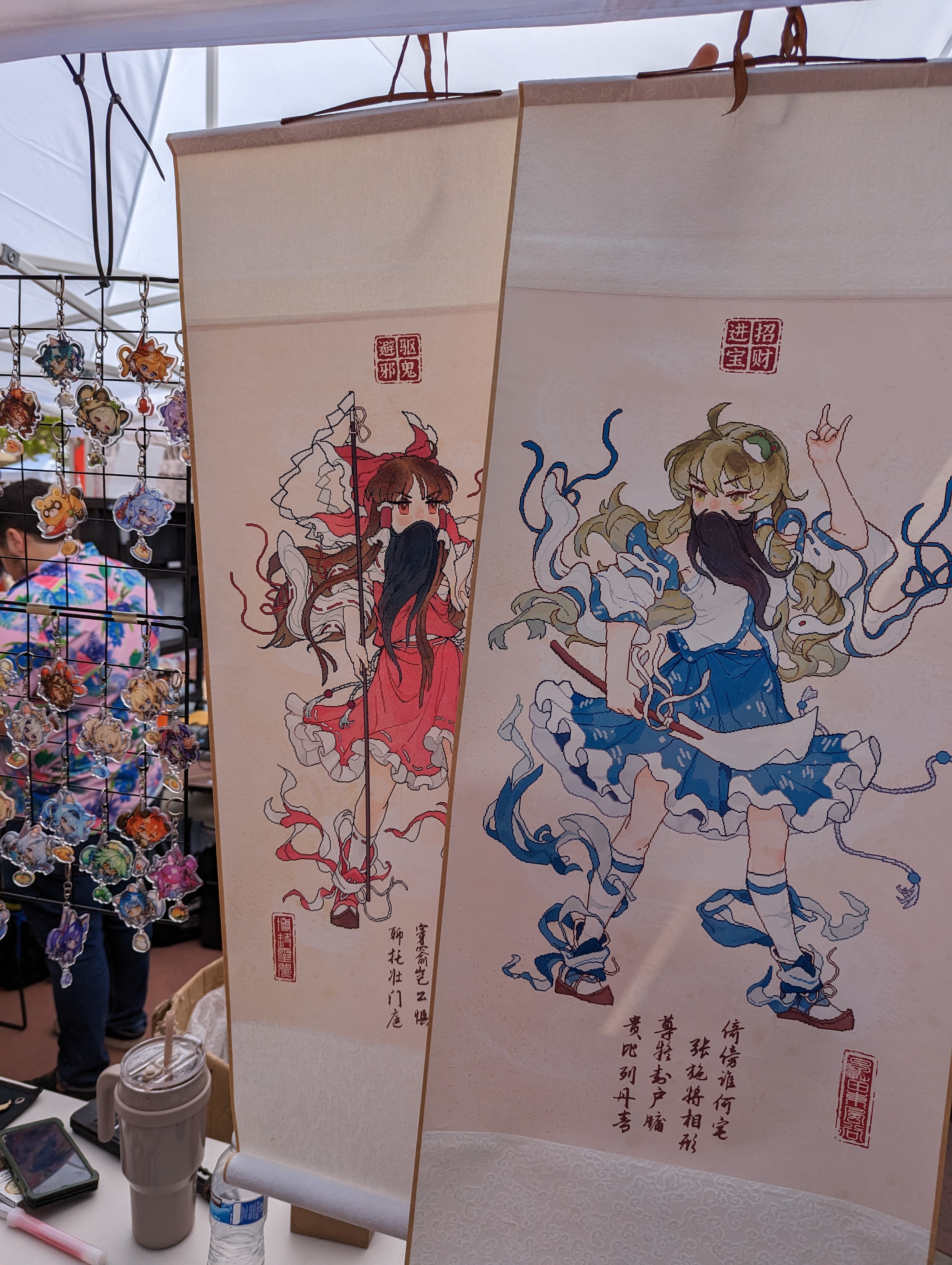 Two white wall scrolls of Reimu Hakurei and Sanae Kochiya drawn in the style of Chinese door gods